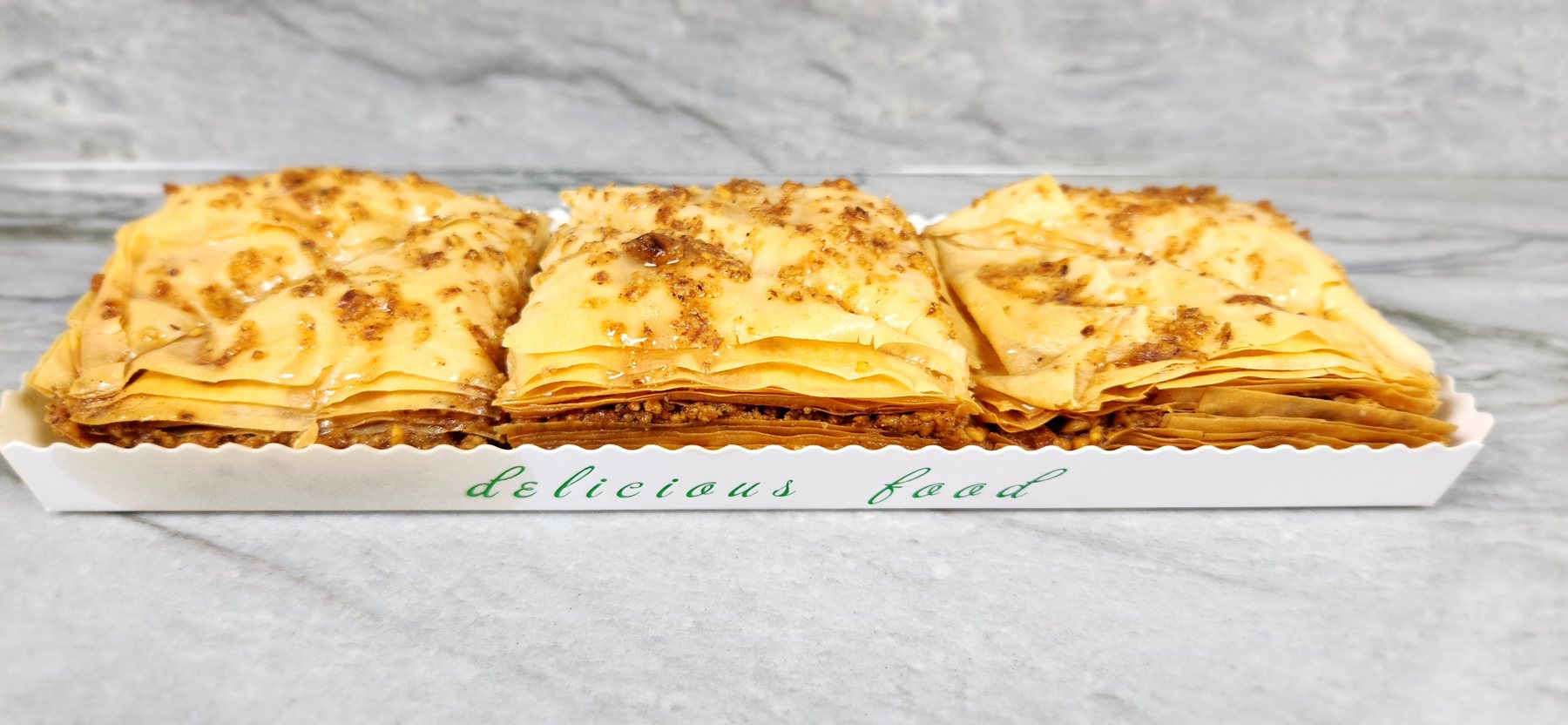 A tray of golden homemade baklava squares